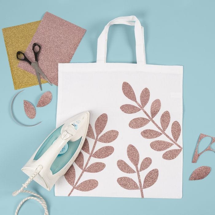 Un sac à provisions décoré de motifs de branches d'épinette en film à repasser