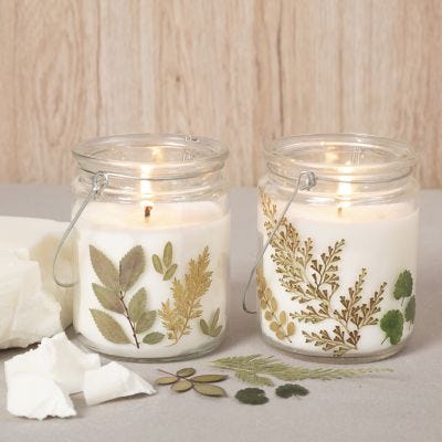 Bougies en cire de colza dans une lanterne en verre décorée de fleurs séchées