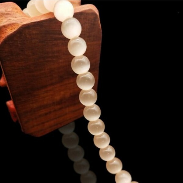 Fil de 63 perles ronde naturelle 6 mm OEIL DE CHAT ECRU - Photo n°1