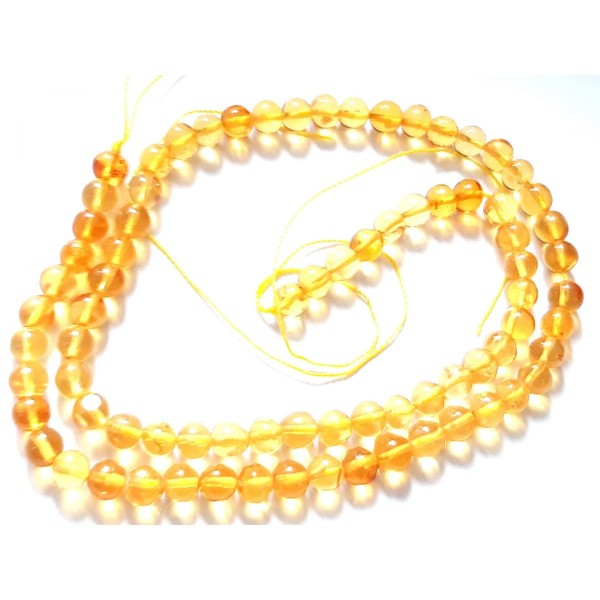 Fil de 75 perles rondes irrégulières 5- 6mm en ambre jaune - Photo n°2