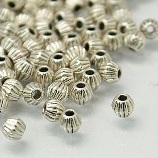 50 petites perles métal argenté antique 4 mm forme TOUPIE - Photo n°1